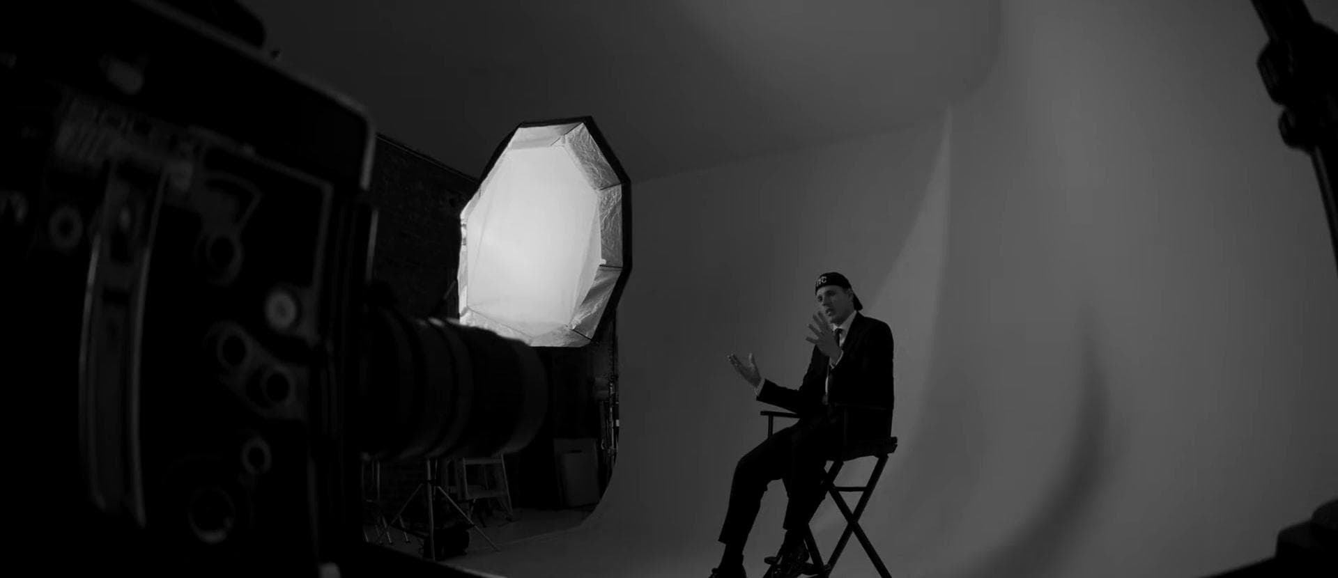 Olav Stubberud on a director’s chair under one octabox, his camera in the foreground, from Finding the Base